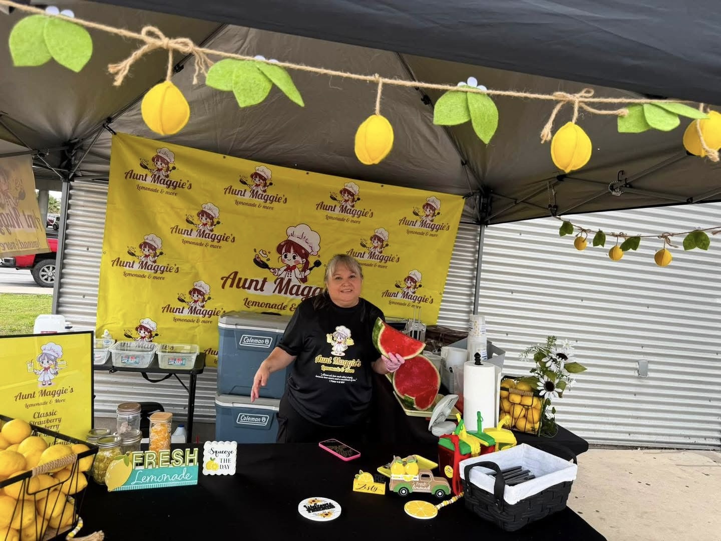 Maggie at the stand holding fresh watermelon