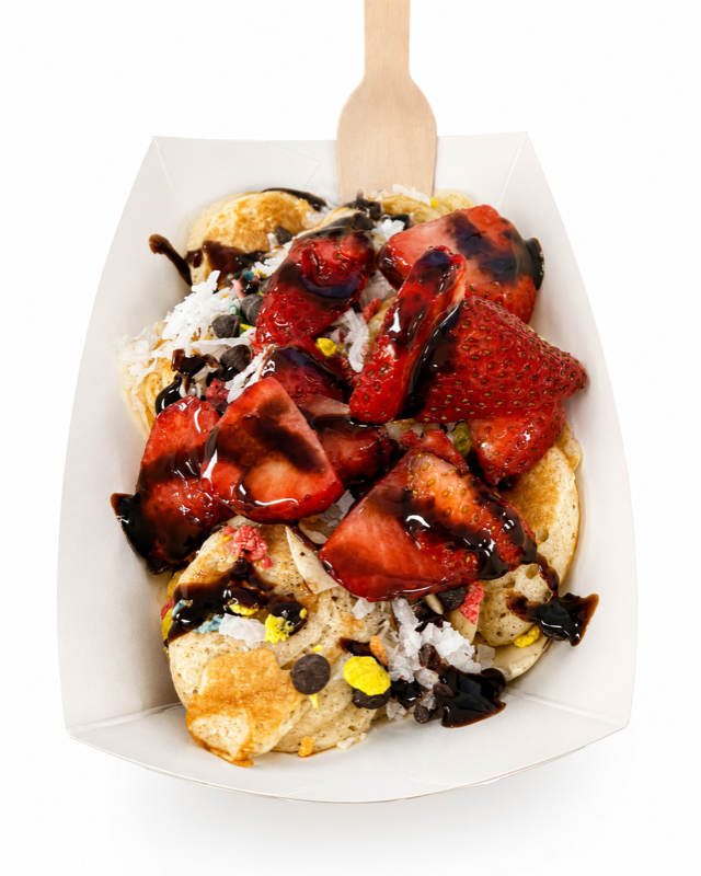 Mini waffles topped with strawberries and chocolate drizzle